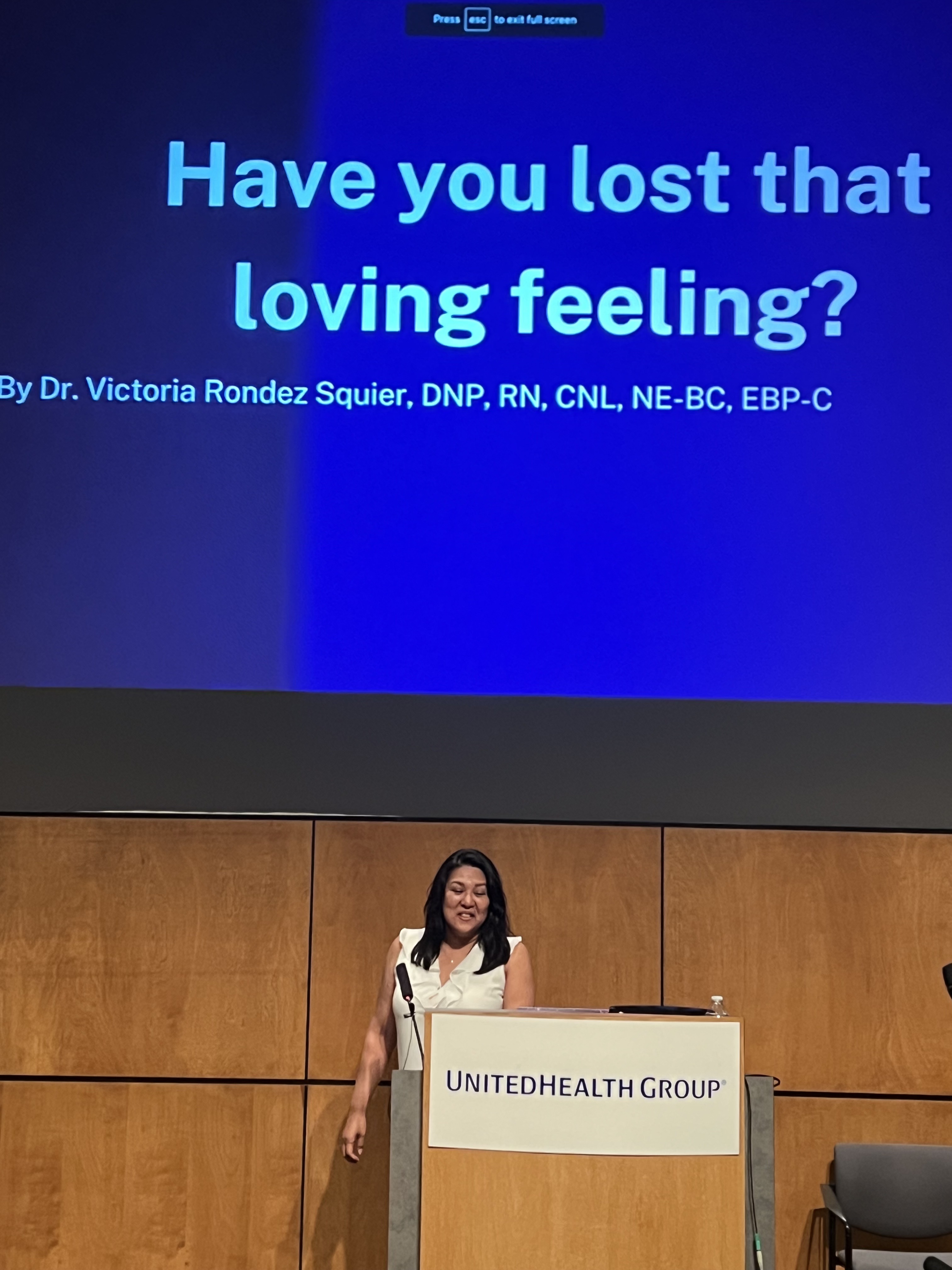 Dr. Victoria Squier speaking at a podium